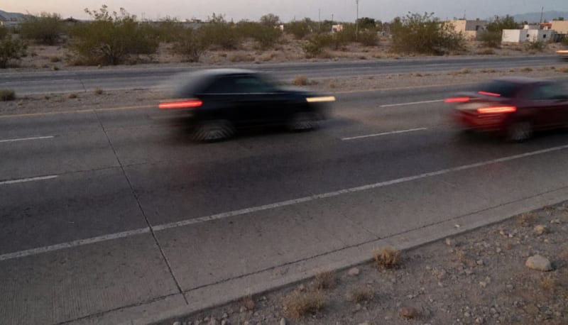 Vehículos circulando a alta velocidad en una carretera del norte de Chihuahua durante el atardecer