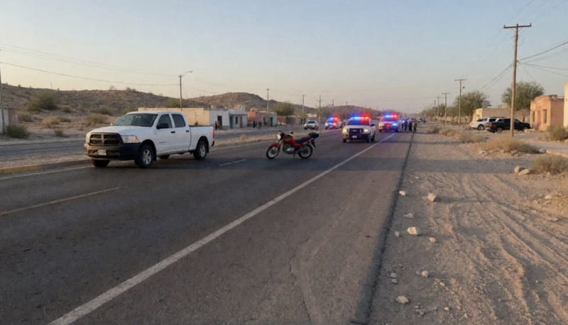 Camioneta blanca y motocicleta roja sobre la carretera a Naica con luces de emergencia reflejándose en el asfalto